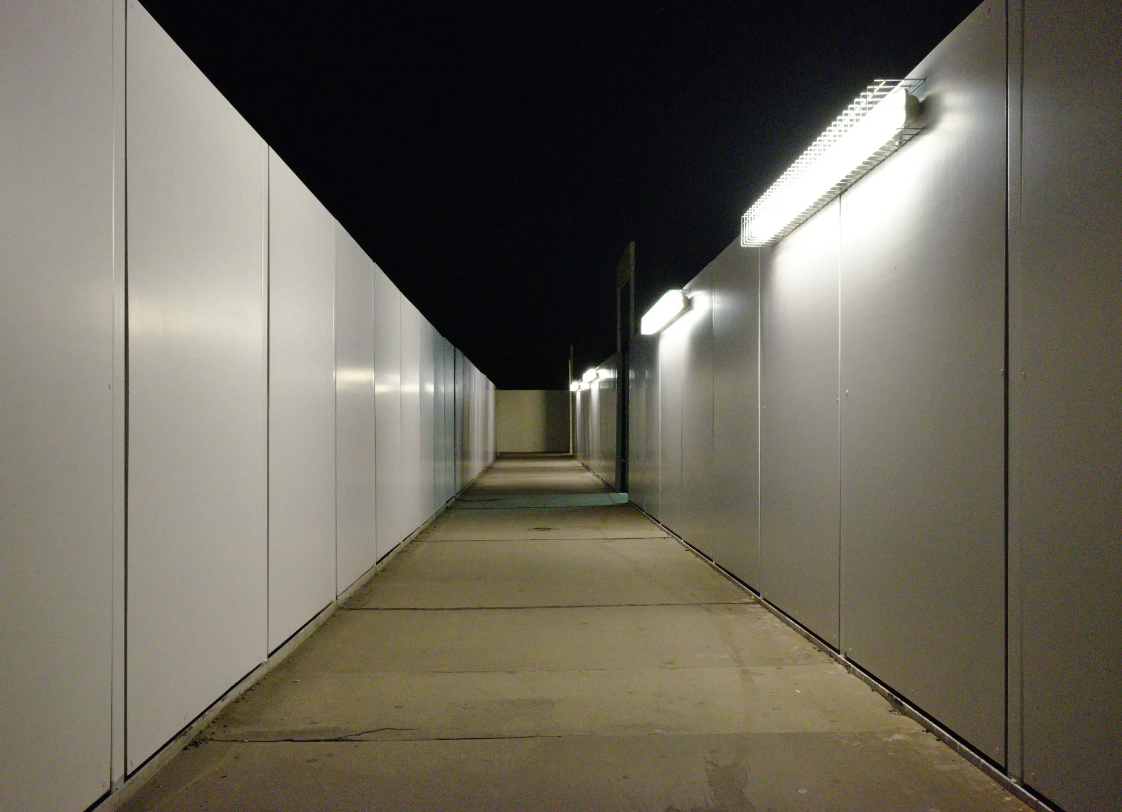 walkway at night lit by lights