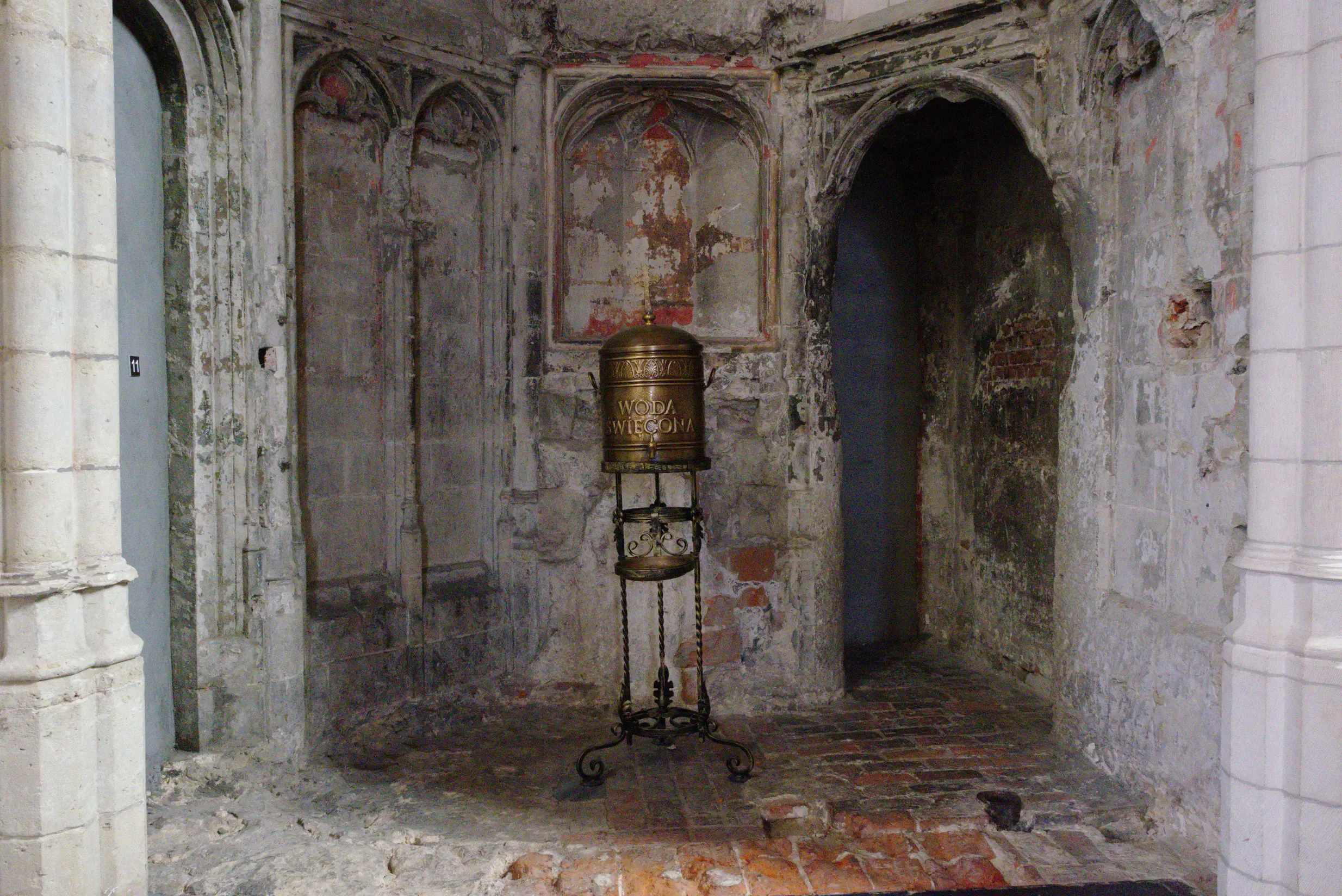 a bell on a stand in an old building